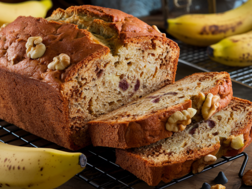 Easy banana bread recipe with a golden-brown loaf, sliced to show a soft, moist crumb.